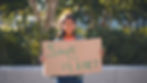Child holding "save the planet" sign
