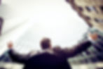 A man looking up at the sky with his arms out in disbelief
